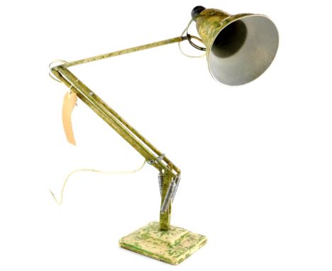 A cream Anglepoise lamp, with green camouflage decoration.