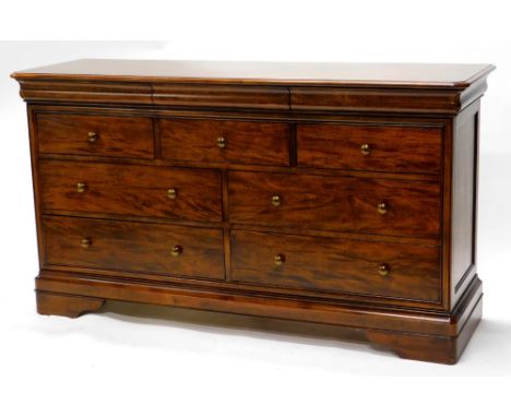 A continental mahogany chest of drawers, with a moulded frieze above an arrangement of three short and four long drawers, eac