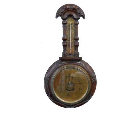 A late 19thC aneroid barometer, in a carved oak case (AF), 47cm long.