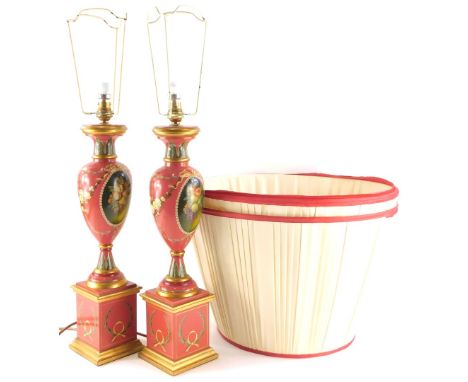 A pair of baluster shaped table lamp bases, each painted with a fruit, flowers, swags etc., on a pink ground with a square ba