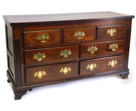 An early 19thC Lancashire mahogany chest, with a hinged top enclosing a vacant interior above three false drawers and four dr