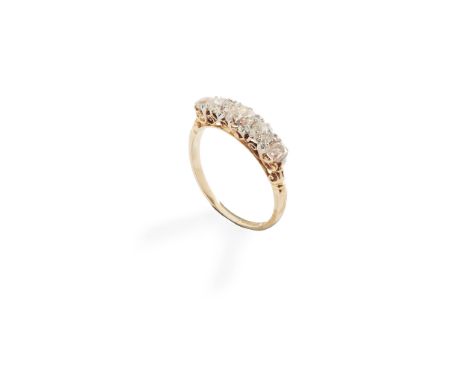 A five-stone diamond ring claw-set with five graduated old round-cut diamonds, scrolling detail to gallery, stamped 18ct(Ring