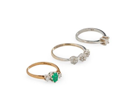 Three gem-set rings including a 9ct gold emerald and diamond three-stone ring, a platinum mounted single-stone princess-cut d