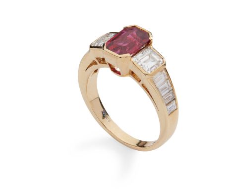 A ruby and diamond ring part collet-set with an octagonal step-cut ruby, flanked to either side by a square step-cut diamond,