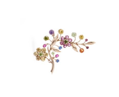 A multi-gem floral spray brooch set throughout graduated round-cut coloured gems, including ruby, sapphire, garnet, amethyst,