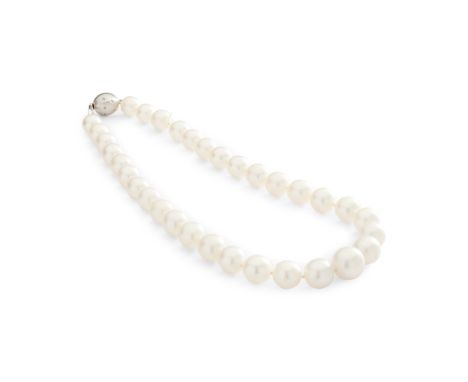 A South Sea pearl necklace composed of a single row of graduated South-Sea pearls, to a globular clasp gypsy-set with round-c