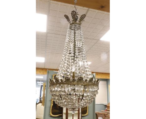 A brass chandelier with faceted drops, Louis XVI style, 20th century, h 90 x Ø 44 cm.