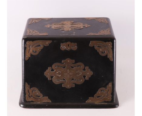 An ebonised wooden cigar cabinet with brass fittings, Germany, ca. 1880. Behind the slanted flap interior with five drawers, 