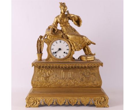 A fire-gilded Louis Philippe mantel clock, France, ca. 1840. Crowning of a young lady dressed in Chinese style, base with rel