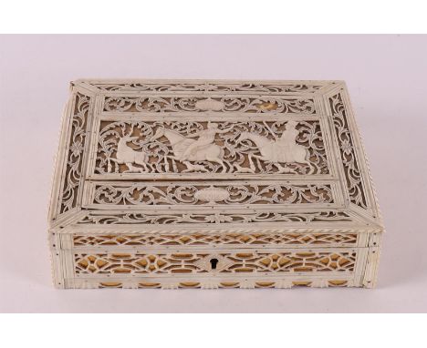 An openwork bone lidded box on wooden base, Arkhangelsk, Kholmogory, Russia, 18th century. Openwork decoration of hunting sce
