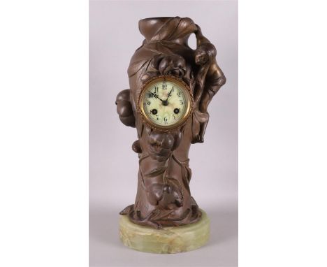 A bronzed white metal Art Nouveau mantel clock, France, late 19th century. Decoration of an elegant woman next to a wealth of