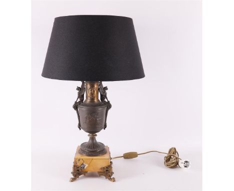 A bronzed white metal Empire style table lamp with fabric shade, late 19th century, h 44 cm (measured without shade).