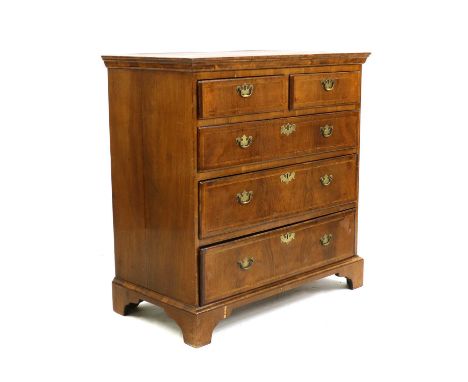 A George II walnut chest of drawers, with later elements, the crossbanded top, above arrangement of two short and three long 