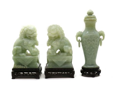 A group of jade carvings,of recent manufacture, to include a pair of Temple Lions, and a twin-handled vase and cover, on hard