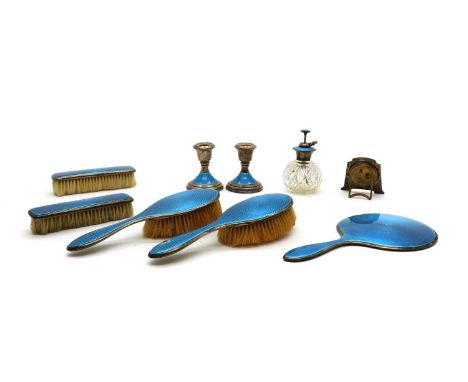 A silver dressing table set,Birmingham 1945, all decorated in blue guilloche enamel, comprising two hand brushes, 24cm high, 