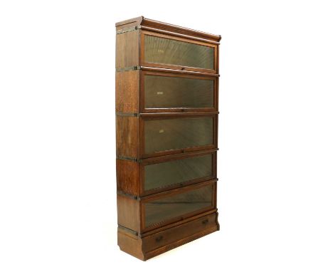 An oak Globe Wernicke five-section bookcase,early 20th century, each section with a typical hinged and glazed door, with a to