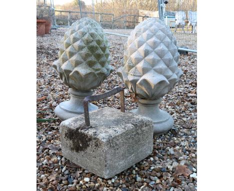 A pair of Haddonstone pineapple pillar finials,each on a socle, 31cm wide57cm highand a boot scraper28cm square (3)Condition 