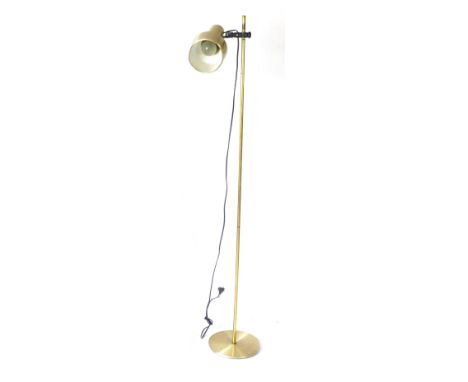A 1970's brass coloured standard lamp, the single adjustable shade on a straight shaft
 CONDITION REPORT: Working order unkno