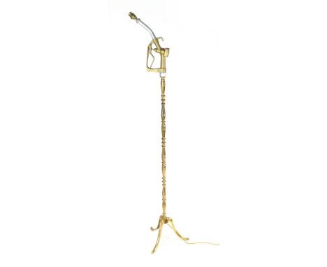 A brass standard lamp, the light fitting formed from a gilt petrol pump

 CONDITION REPORT: Working order unknown 