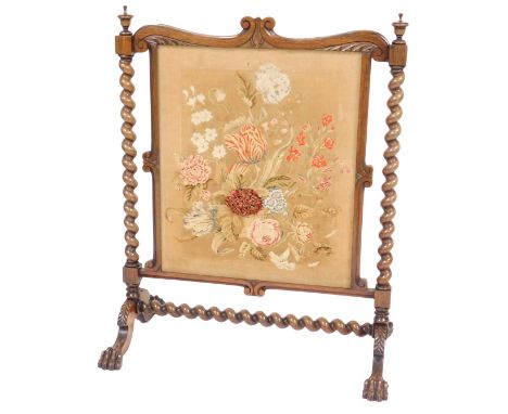 A early Victorian rosewood and woolwork firescreen, the central square panel embroidered with flowers, raised on barleytwist 