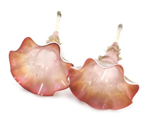 A pair of Victorian cranberry and opaline glass epergne trumpets, of frilled form, 28cm high.
