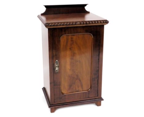 A Victorian style mahogany pot cupboard, with a panelled door, enclosing a single shelf, raised on bracket feet, 80cm high, 4