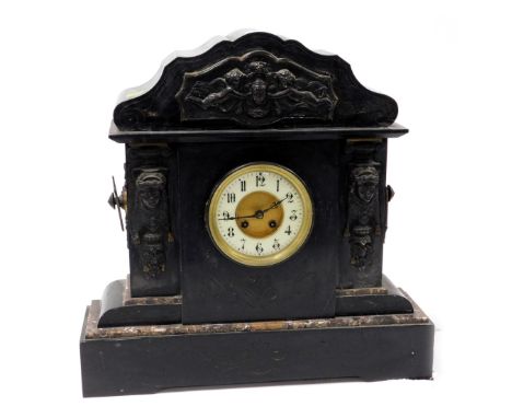 A late 19thC black slate mantel clock, with cherub, urn and Medusa embossed panels, with a cream dial, 49cm high, 50cm wide, 