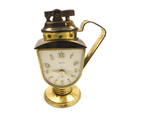 A mid 20thC Swiza brass cased novelty bedside clock, with integral cigarette lighter, shield shaped dial bearing Arabic numer