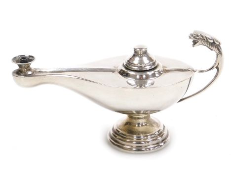 An Eastern silver plated Aladdin's lamp oil lamp, with dragon mask handle on staggered base, 6cm high, 11cm wide. 