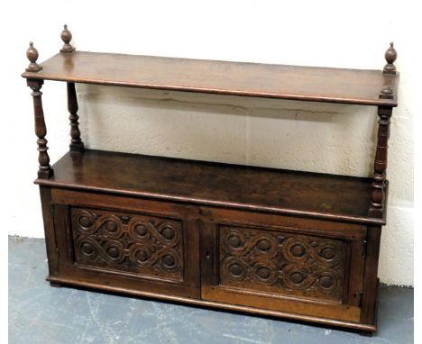 A Victorian oak wall hanging cupboard, with a shelf top raised on turned supports, above a pair of scrolling carved panelled 