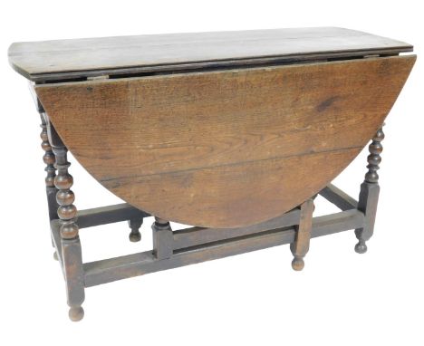 A 17thC oak gate leg table, with oval drop leaf top, frieze drawer, bobbin turned legs and moulded square stretchers and turn