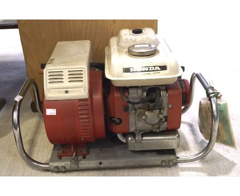 A Honda petrol generator, model E800, with the original instruction manual