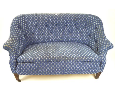 A small two seater blue upholstered sofa, with button back and arms, raised on front carved tapering supports, L142cm x D70cm