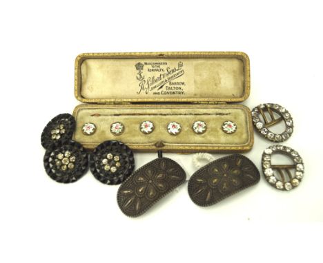 Seven vintage belt buckles and a boxed set of ceramic buttons, the buttons decorated with flowers