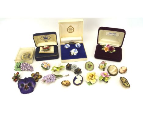 A collection of ceramic brooches, mostly modelled as flowers, including examples by Sylvac