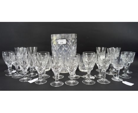 An assortment of cut glassware, including Waterford crystal, beakers, spirit glasses, etc