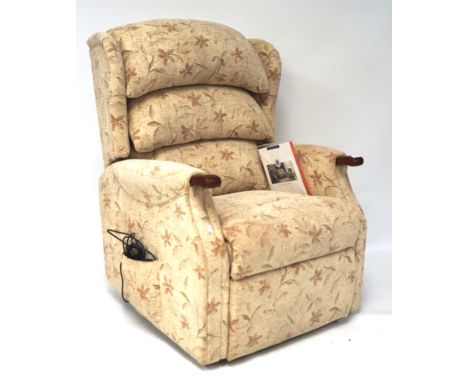 A Celebrity Furniture 'Westbury Grande Recliner' electric chair, brand new, upholstered in floral fabric, together with elect