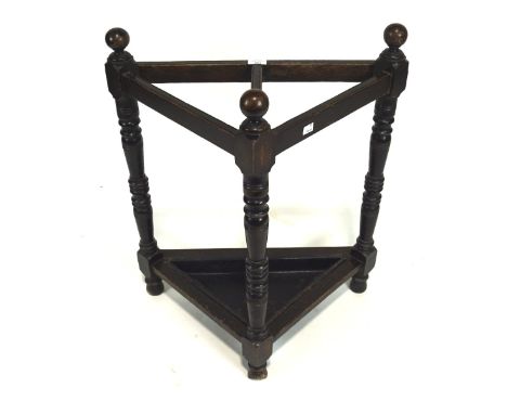 An early/mid-20th century oak umbrella/stickstand, of triangular form, with original metal tray, raised on turned supports, H