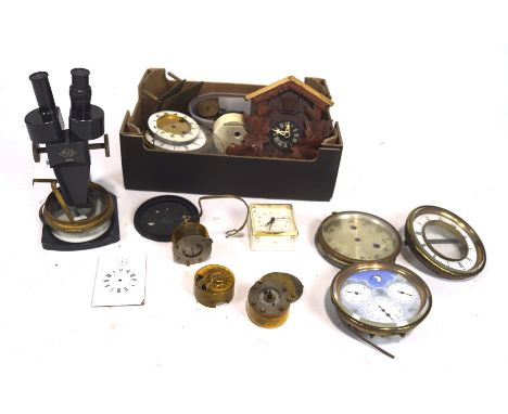 An assortment of clock parts and similar items, including a part cuckoo clock, Prior x 4.0 microscope 22806, clock dials, etc