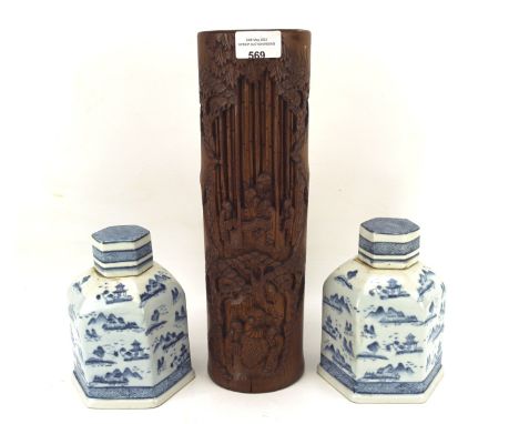 A pair of Chinese style blue and white ceramic tea caddies and a bamboo brushpot, the brushpot with traditional carved decora