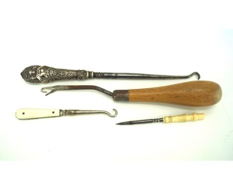Four button hooks and sewing tools, including a bone handled stiletto, silver handled button hook, etc