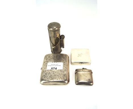 Three silver objects and a table lighter, the silver comprising an engraved cigarette case, vesta case and a small ladies com