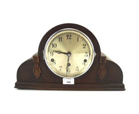 An early 20th century oak cased mantel clock, the silvered dial with Arabic numerals denoting hours, H22cm 