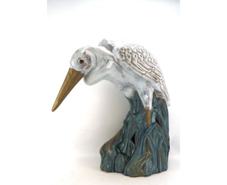 A large glazed ceramic figure of a crane, perched upon some reeds, approx. H65cm 