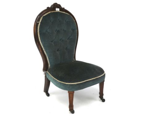 A mahogany nursing chair, with button back blue upholstery, on original castors, H85cm