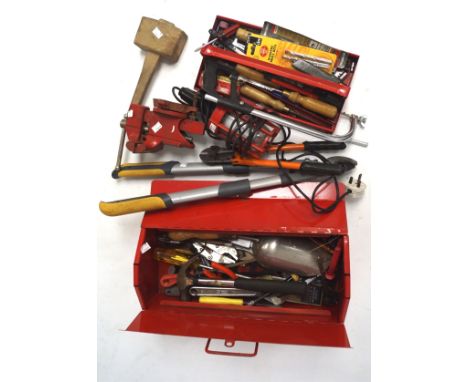 An assortment of tools, to include a workbench vice, saw and a mallet, all held in a red tool box