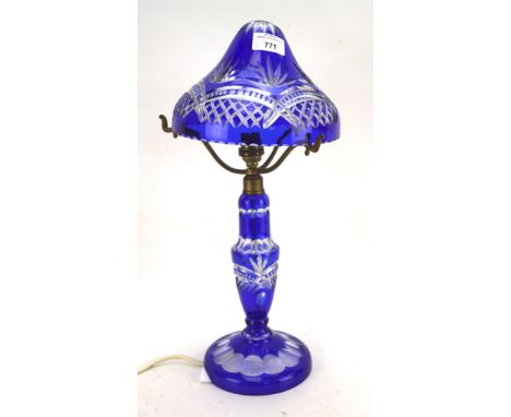 A cut-glass blue stained electric lamp, mounted on a circular base, H44cm