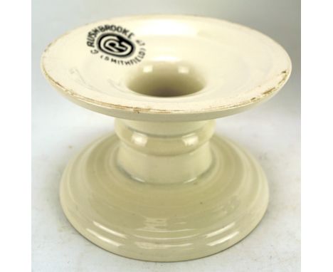 A ceramic 'Harris Stand' by G Rushbrooke Smithfield Ltd, on a circular base with white glaze, H11.5cm