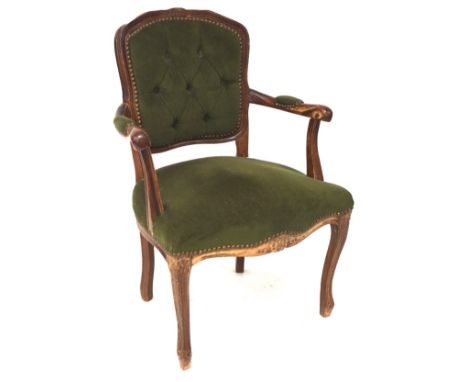 A Louis VX style elbow chair, with a carved mahogany frame, upholstered in green velvet with button back, H87cm 