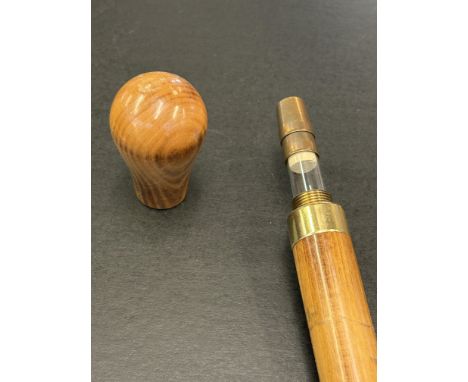 Walking stick with spring loaded concealed flask 